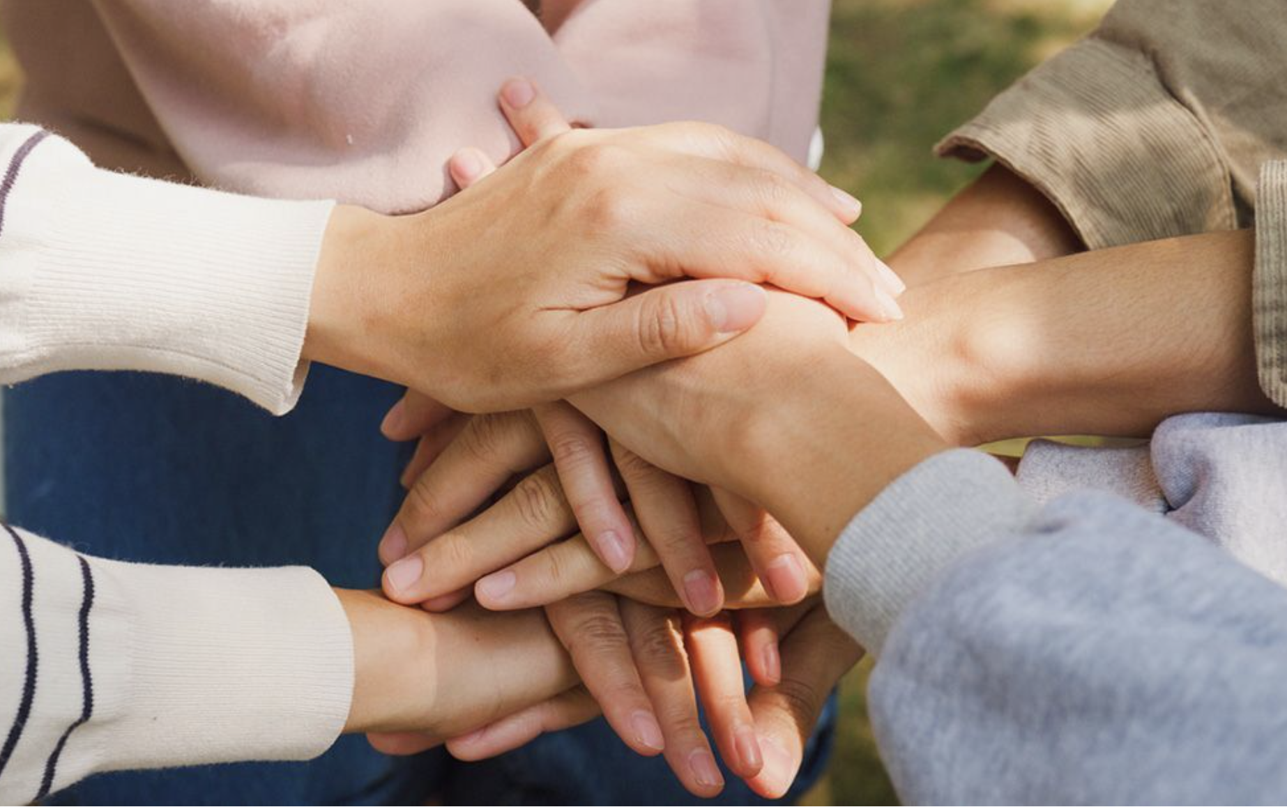 A photo of hands together providing support